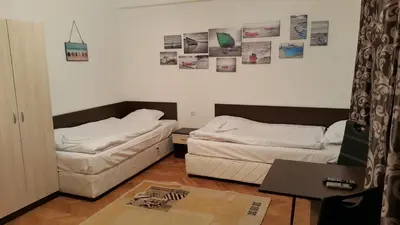 a living room with two beds and a table at Guest Rooms Old Captain in Burgas City