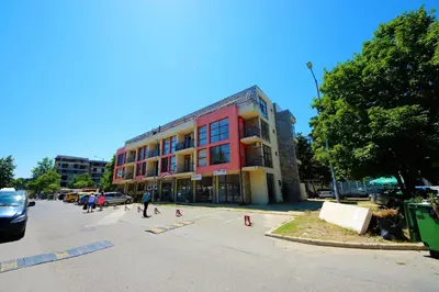 a group of people in a parking lot in front of a building at Menada Crystal Park Apartments in Sunny Beach