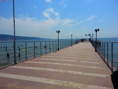 a pier with people swimming in the water at Menada Crystal Park Apartments in Sunny Beach