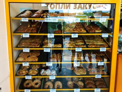 a display case filled with lots of different types of pastries at Menada Crystal Park Apartments in Sunny Beach