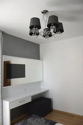 a living room with a television and a chandelier at Stela Apartments in Obzor