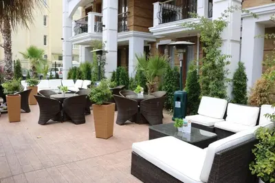 a patio with couches and tables in a building at Private Apartments in Harmony Suites Dream Island in Sunny Beach