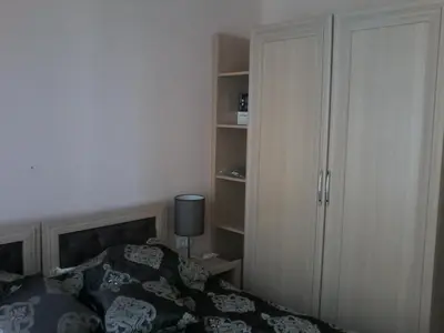 a bedroom with a bed and a book shelf at Private Apartments in Harmony Suites Dream Island in Sunny Beach