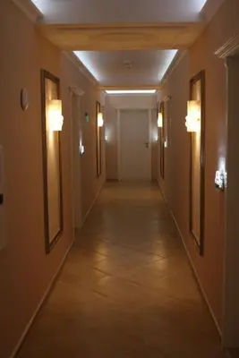 a hallway in a building with lights on the walls at Private Apartments in Harmony Suites Dream Island in Sunny Beach