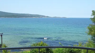 a boat in the middle of the water at Dobrevi Guest House in Primorsko