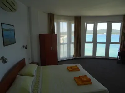 a bedroom with a bed with two towels on it at Dobrevi Guest House in Primorsko