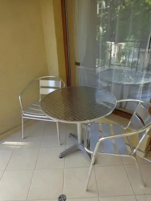 a table and two chairs and a table and a window at Comfort Zamenhof in Varna City