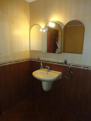 a bathroom with a sink and a mirror at Comfort Zamenhof in Varna City