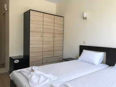 a bedroom with two beds and a large closet at Jane Guest House in Nesebar