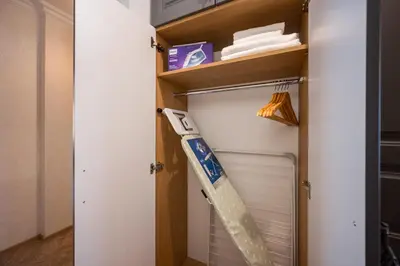 a closet with a baseball bat in it at Prestige Central Apartments in Varna City
