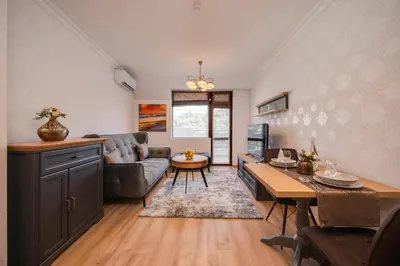a living room with a couch and a table at Prestige Central Apartments in Varna City