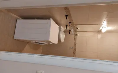 a bathroom with a toilet and a mirror at Casa del Sol Apartments in Sunny Beach