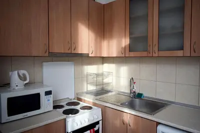 a kitchen with a microwave and a stove top oven at Sea Garden in Burgas City