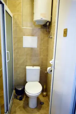 a small bathroom with a toilet and a sink at Sea Garden in Burgas City