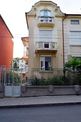 a building with a fence in front of it at Sea Garden in Burgas City