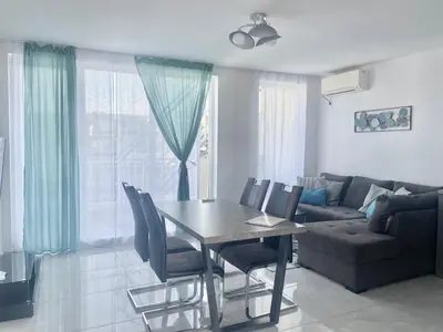 a living room with a table and a couch at Apartments in Sunny Island Complex in Chernomorets
