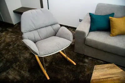 a chair and a couch in a living room at Best Western PLUS Premium Inn in Sunny Beach