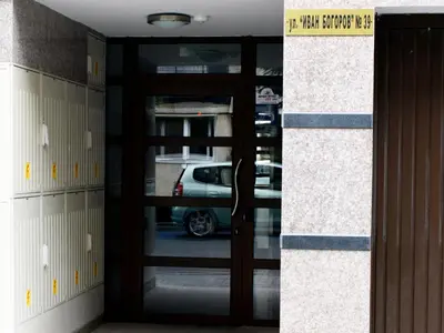 a door in a locker room with a car in it at Flora Beach Apartaments in Burgas City
