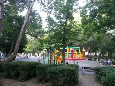 a playground in a park with a colorful playground at Flora Beach Apartaments in Burgas City