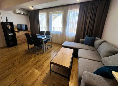 a living room with a couch and a table at Maisonette Sevastiyan in Varna City