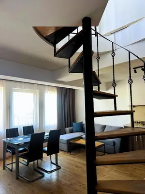a living room with a loft bed and a dining room at Maisonette Sevastiyan in Varna City