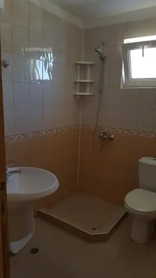 a bathroom with a shower with a toilet and a sink at Villa Krisia Apartments in Sozopol