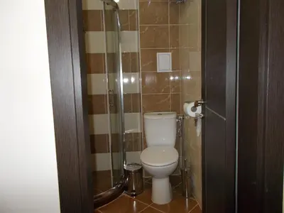 a bathroom with a toilet and a glass shower at Apartment Bliznaci in Pomorie