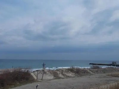 a view of the ocean from a sandy beach at Apartment Bliznaci in Pomorie