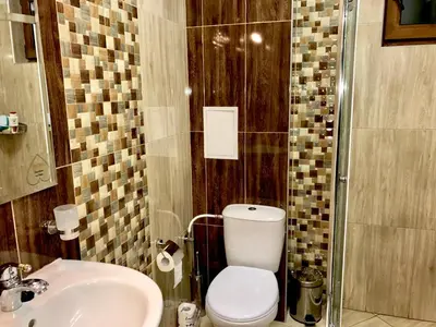 a bathroom with a toilet and a sink at Beach Apartments Pomorie in Pomorie
