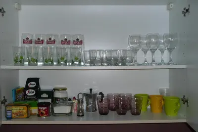 a shelf with glasses and other items on it at Apartament Aheloy in Aheloy