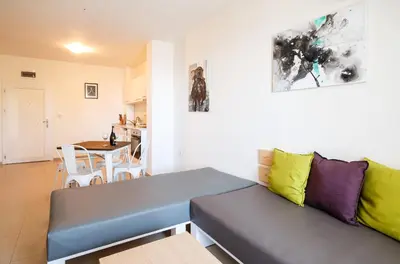 a living room with a couch and a table at NLV Seaside Apartments in Sunny Beach