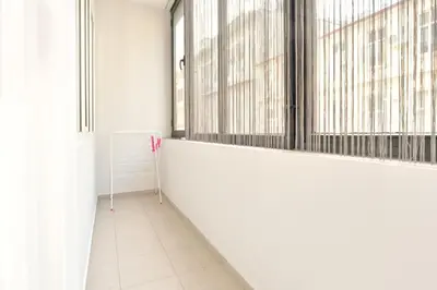 a hallway with white walls and large windows at Central studio #2 in Burgas City