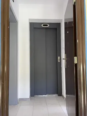 a hallway with a blue door in a room at Pearl Sunshine Appartments in Primorsko