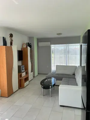 a living room with a couch and a table at Pearl Sunshine Appartments in Primorsko
