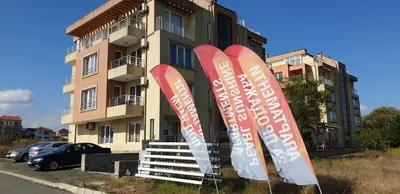 a building with signs in front of it at Pearl Sunshine Appartments in Primorsko