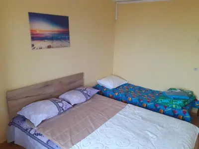 a bedroom with a bed and a picture on the wall at Kraybrezhna 3 in Pomorie