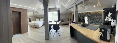a hotel room with a bedroom and a bed at Guest House SG-BROTHERS in Obzor