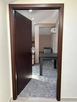 a door leading into a room with a table at Guest House SG-BROTHERS in Obzor