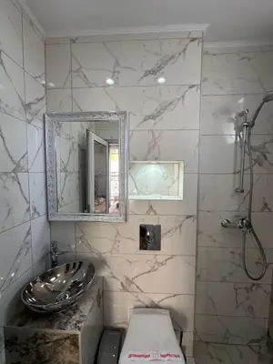 a bathroom with a sink and a toilet and a mirror at Dracena Guesthouse in Ravda