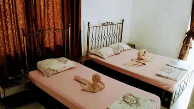two beds with stuffed animals on them in a room at Dracena Guesthouse in Ravda