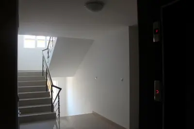a staircase in a white room with a stair case at Studio Martin in Pomorie