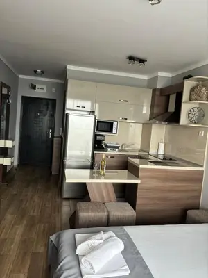 a kitchen with a counter and a kitchen with a sink at Studio Sea Pearl in Pomorie