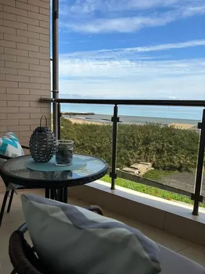 a balcony with a table and a view of the ocean at Studio Sea Pearl in Pomorie