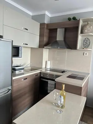 a kitchen with two wine glasses on a counter at Studio Sea Pearl in Pomorie