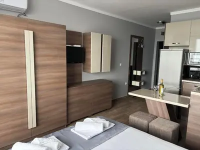 a room with a kitchen with a bed and a counter at Studio Sea Pearl in Pomorie