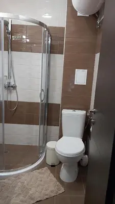 a bathroom with a toilet and a shower at Studio Sea Pearl in Pomorie