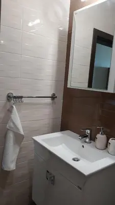 a bathroom with a white sink and a mirror at Studio Sea Pearl in Pomorie
