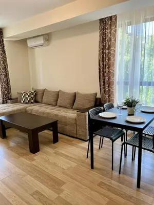 a living room with a couch and a table at Apartments Flora 1 in Burgas City