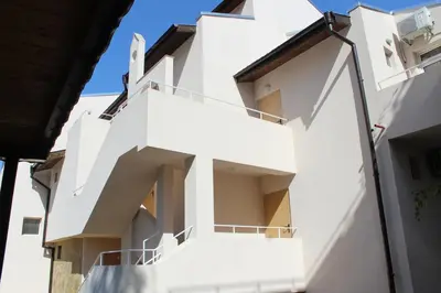 a white building with balconies on the side at Siana House in Ravda