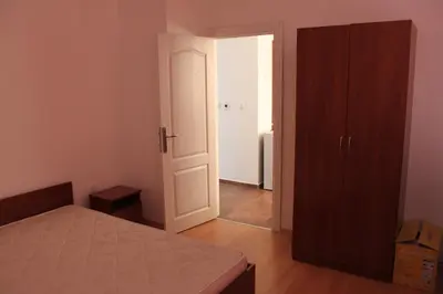 a bedroom with a bed and an open door at Abelia Residence Apartment Regina in Sunny Beach